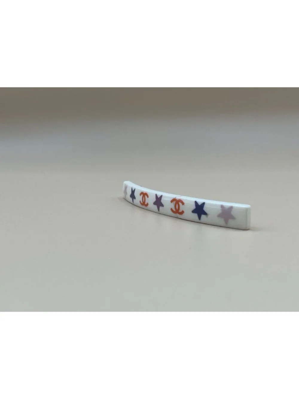 Authentic vintage Chanel bar barrette in cream-white resin, printed with two red